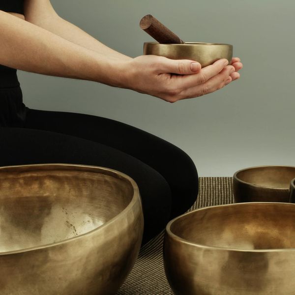 A person meditating peacefully, surrounded by an aura of calm energy.